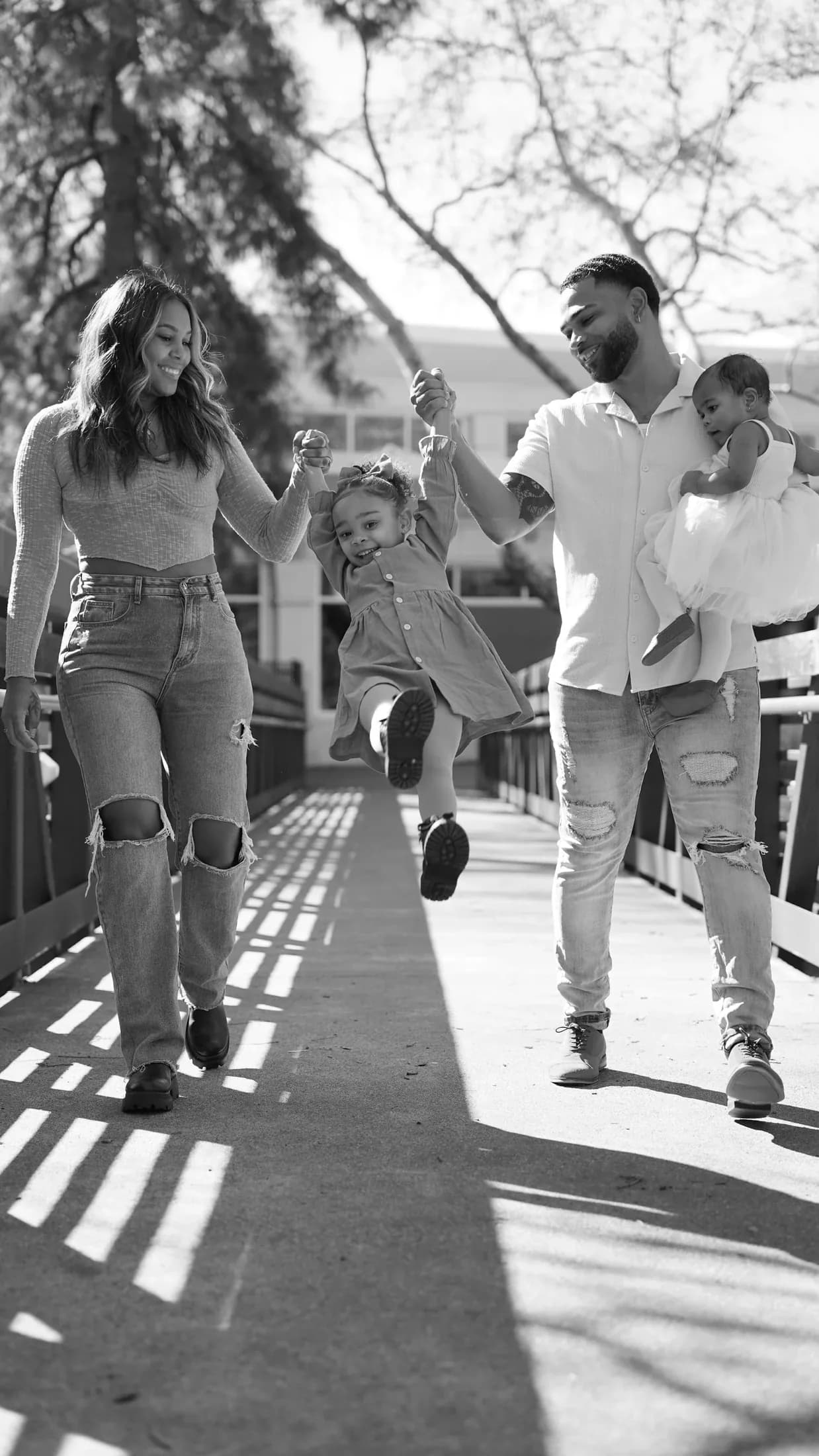 The Cusano family walking together on a bridge